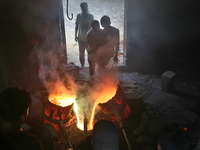 Liquid iron is flowing into the prepared propeller mould at a dockyard on the bank of River Buriganga in Dhaka, Bangladesh (