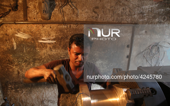 Bangladeshi worker works in a dockyard on the bank of River Buriganga, Dhaka, Bangladesh. 