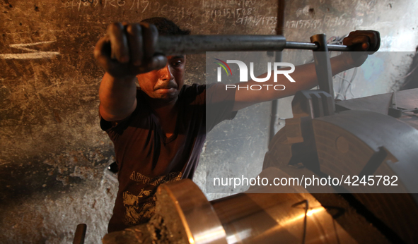 Bangladeshi worker works in a dockyard on the bank of River Buriganga, Dhaka, Bangladesh. 