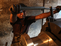 Bangladeshi worker works in a dockyard on the bank of River Buriganga, Dhaka, Bangladesh. (