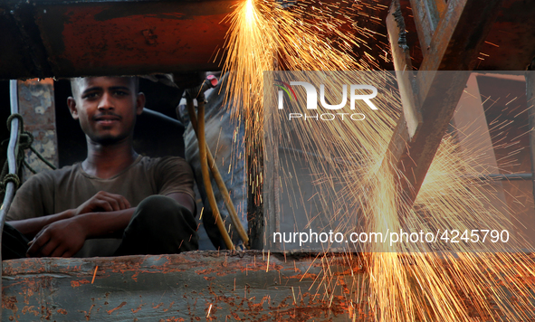 Bangladeshi worker works in a dockyard on the bank of River Buriganga, Dhaka, Bangladesh. 