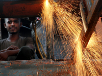 Bangladeshi worker works in a dockyard on the bank of River Buriganga, Dhaka, Bangladesh. (