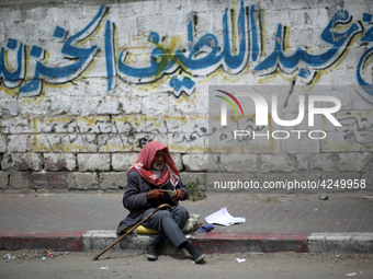 A Palestinian man sits on a sidewalk, in Gaza City  May 1, 2019.
 (