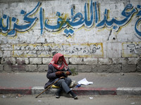 A Palestinian man sits on a sidewalk, in Gaza City  May 1, 2019.
 (