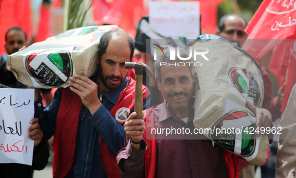 Palestinians take part in a rally marking International Workers' Day, or Labour Day, in Gaza City May 1, 2019. 