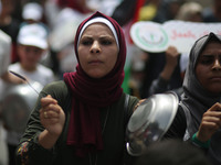 Palestinians  bang on pots during a rally marking International Workers' Day, or Labour Day, in Gaza City May 1, 2019. 
 (