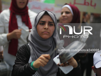 Palestinians  bang on pots during a rally marking International Workers' Day, or Labour Day, in Gaza City May 1, 2019. 
 (