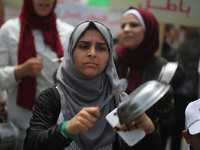 Palestinians  bang on pots during a rally marking International Workers' Day, or Labour Day, in Gaza City May 1, 2019. 
 (