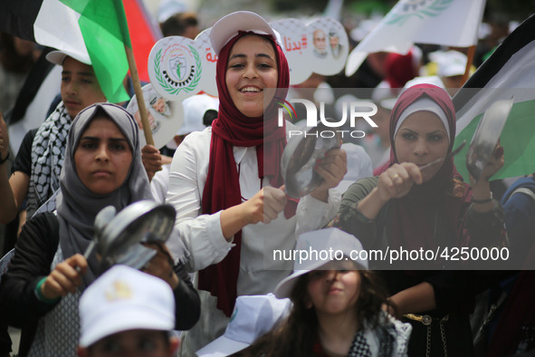 Palestinians  bang on pots during a rally marking International Workers' Day, or Labour Day, in Gaza City May 1, 2019. 
 