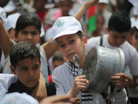 Palestinians  bang on pots during a rally marking International Workers' Day, or Labour Day, in Gaza City May 1, 2019. 
 (