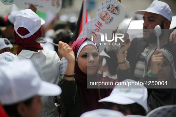 Palestinians  bang on pots during a rally marking International Workers' Day, or Labour Day, in Gaza City May 1, 2019. 
 