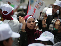 Palestinians  bang on pots during a rally marking International Workers' Day, or Labour Day, in Gaza City May 1, 2019. 
 (