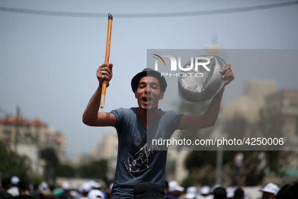 Palestinians  bang on pots during a rally marking International Workers' Day, or Labour Day, in Gaza City May 1, 2019. 
 