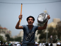 Palestinians  bang on pots during a rally marking International Workers' Day, or Labour Day, in Gaza City May 1, 2019. 
 (