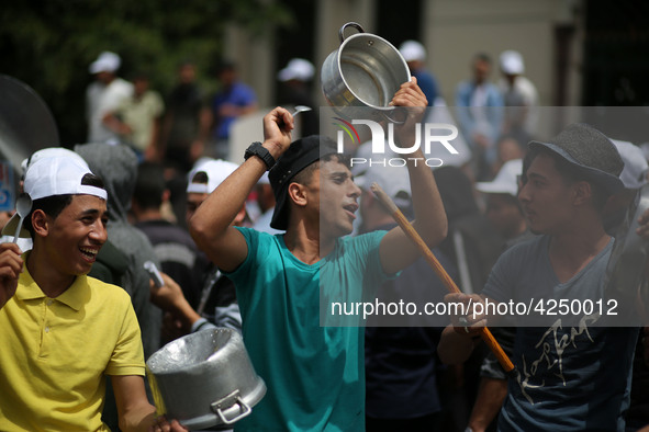 Palestinians  bang on pots during a rally marking International Workers' Day, or Labour Day, in Gaza City May 1, 2019. 
 