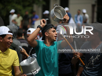 Palestinians  bang on pots during a rally marking International Workers' Day, or Labour Day, in Gaza City May 1, 2019. 
 (