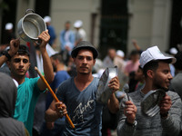 Palestinians  bang on pots during a rally marking International Workers' Day, or Labour Day, in Gaza City May 1, 2019. 
 (