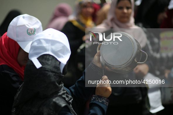 Palestinians  bang on pots during a rally marking International Workers' Day, or Labour Day, in Gaza City May 1, 2019. 
 