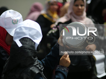 Palestinians  bang on pots during a rally marking International Workers' Day, or Labour Day, in Gaza City May 1, 2019. 
 (