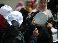 Palestinians  bang on pots during a rally marking International Workers' Day, or Labour Day, in Gaza City May 1, 2019. 
 (