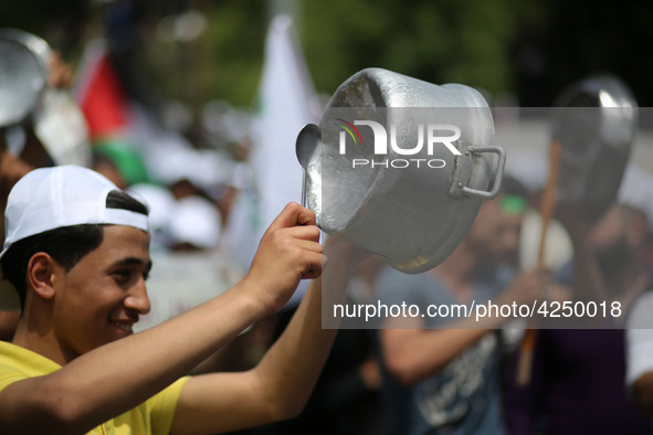 Palestinians  bang on pots during a rally marking International Workers' Day, or Labour Day, in Gaza City May 1, 2019. 
 