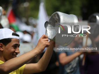 Palestinians  bang on pots during a rally marking International Workers' Day, or Labour Day, in Gaza City May 1, 2019. 
 (