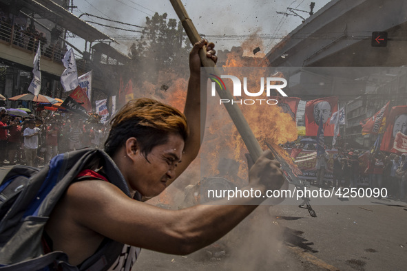 Protesters burn an effigy of Philippine President Rodrigo Duterte during Labor Day demonstrations outside the presidential palace on May 1,...