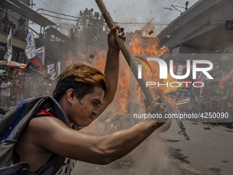 Protesters burn an effigy of Philippine President Rodrigo Duterte during Labor Day demonstrations outside the presidential palace on May 1,...