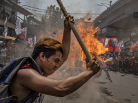 Protesters burn an effigy of Philippine President Rodrigo Duterte during Labor Day demonstrations outside the presidential palace on May 1,...