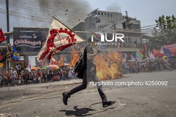 Protesters burn an effigy of Philippine President Rodrigo Duterte during Labor Day demonstrations outside the presidential palace on May 1,...