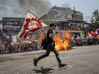 Protesters burn an effigy of Philippine President Rodrigo Duterte during Labor Day demonstrations outside the presidential palace on May 1,...