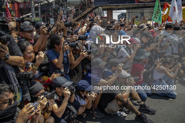 Photographers and cameramen cover protesters taking part in Labor Day demonstrations outside the presidential palace on May 1, 2019 in Manil...