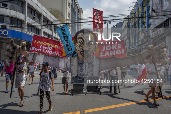 Protesters parade an effigy of Philippine President Rodrigo Duterte as they take part in Labor Day demonstrations outside the presidential p...