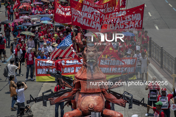 Protesters parade an effigy of Philippine President Rodrigo Duterte as they take part in Labor Day demonstrations outside the presidential p...