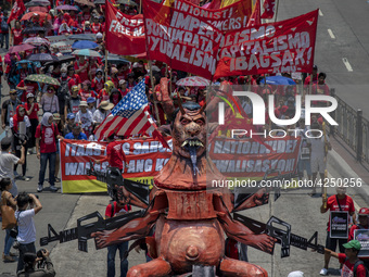 Protesters parade an effigy of Philippine President Rodrigo Duterte as they take part in Labor Day demonstrations outside the presidential p...