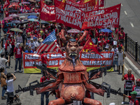 Protesters parade an effigy of Philippine President Rodrigo Duterte as they take part in Labor Day demonstrations outside the presidential p...