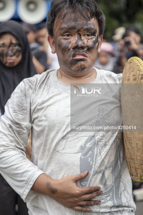 Jakarta, 01 May 2019 : A man with theatrical expression symbolic as how hunger he is as a labor during the demonstration. Thousands of Labor...