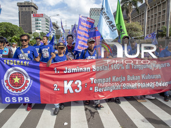 Jakarta, 01 May 2019 :Labors with the banner demanding for more wages ofr labor during the demonstration.  Thousands of Labor filled Merdeka...