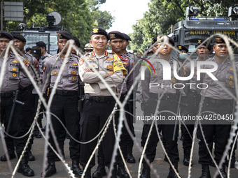 Jakarta, 01 May 2019 : Police guaarding the demonstration with barbwire. Thousands of Labor filled Merdeka Barat Street Jakarta celebrating...