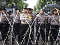 Jakarta, 01 May 2019 : Police guaarding the demonstration with barbwire. Thousands of Labor filled Merdeka Barat Street Jakarta celebrating...