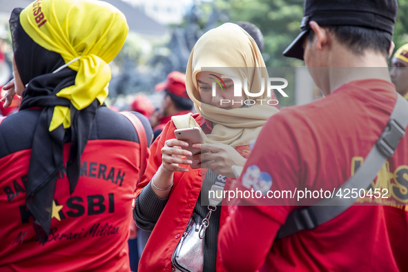 Jakarta, 01 May 2019 : A beautifull hijab Labor during the demonstration. Thousands of Labor filled Merdeka Barat Street Jakarta celebrating...