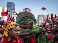 Jakarta, 01 May 2019 : Puppet with USA Flag represent capitalism were lifted up during the dance ceremony at the demonstration location. Tho...