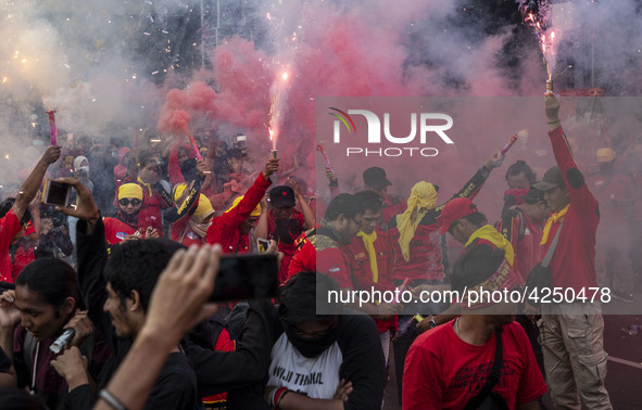 Jakarta, 01 May 2019 : Firecracker lit by labors at the end of the demonstration. Thousands of Labor filled Merdeka Barat Street Jakarta cel...