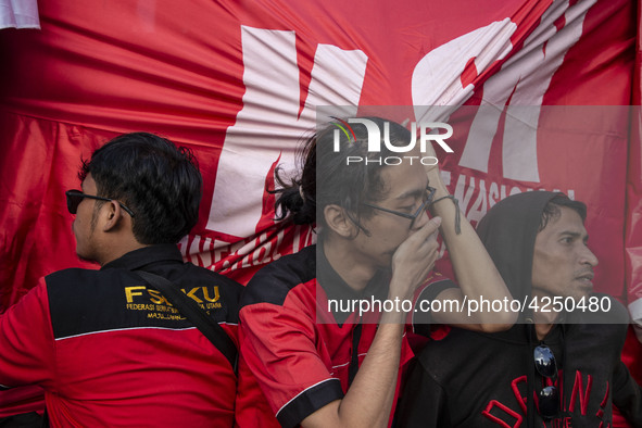 Jakarta, 01 May 2019 : Member of Labors hold to banner after finishing the demonstration. Thousands of Labor filled Merdeka Barat Street Jak...