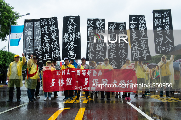 Protesters posing with banners and flags calling for more holidays, paid leave, more labour rights protections. During 2019 Labor Day March...