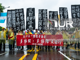 Protesters posing with banners and flags calling for more holidays, paid leave, more labour rights protections. During 2019 Labor Day March...