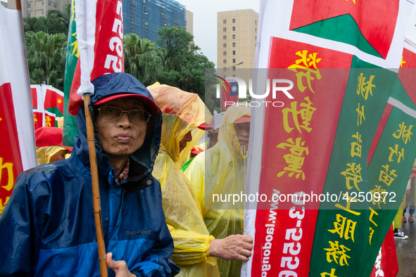 A Protester posing with a flag  between banners calling for more holidays, paid leave, more labour rights protections. During 2019 Labor Day...