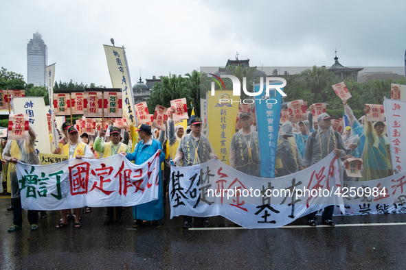 Protesters posing with banners and flags calling for more holidays, paid leave, more labour rights protections. During 2019 Labor Day March...