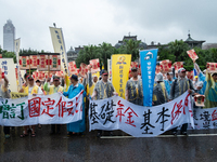 Protesters posing with banners and flags calling for more holidays, paid leave, more labour rights protections. During 2019 Labor Day March...