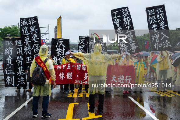 Protesters posing with banners and flags calling for more holidays, paid leave, more labour rights protections. During 2019 Labor Day March...